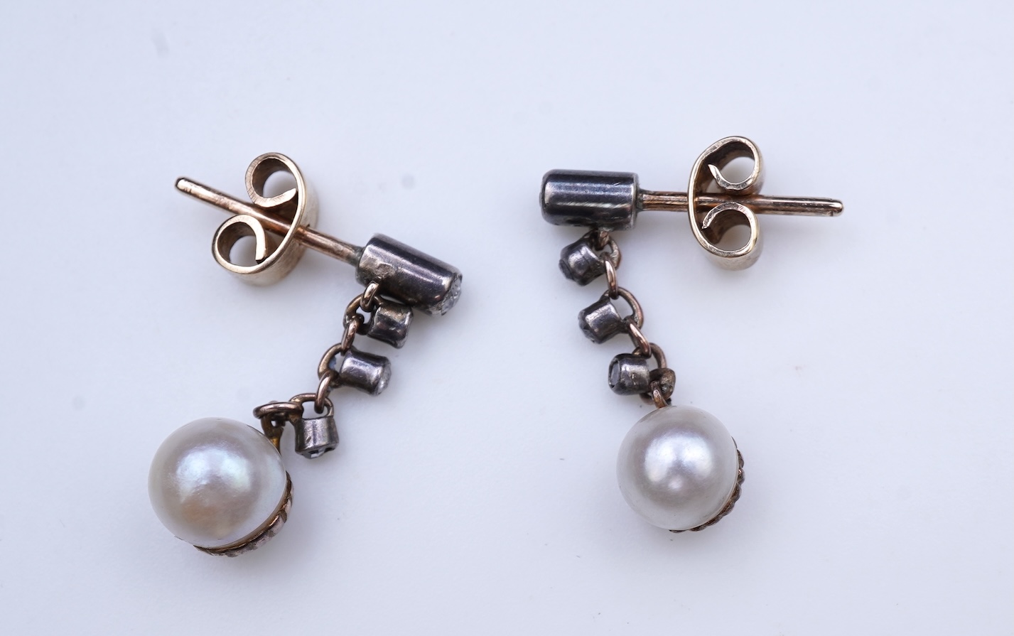 A pair of cultured pearl and diamond earrings, early 20th century and later